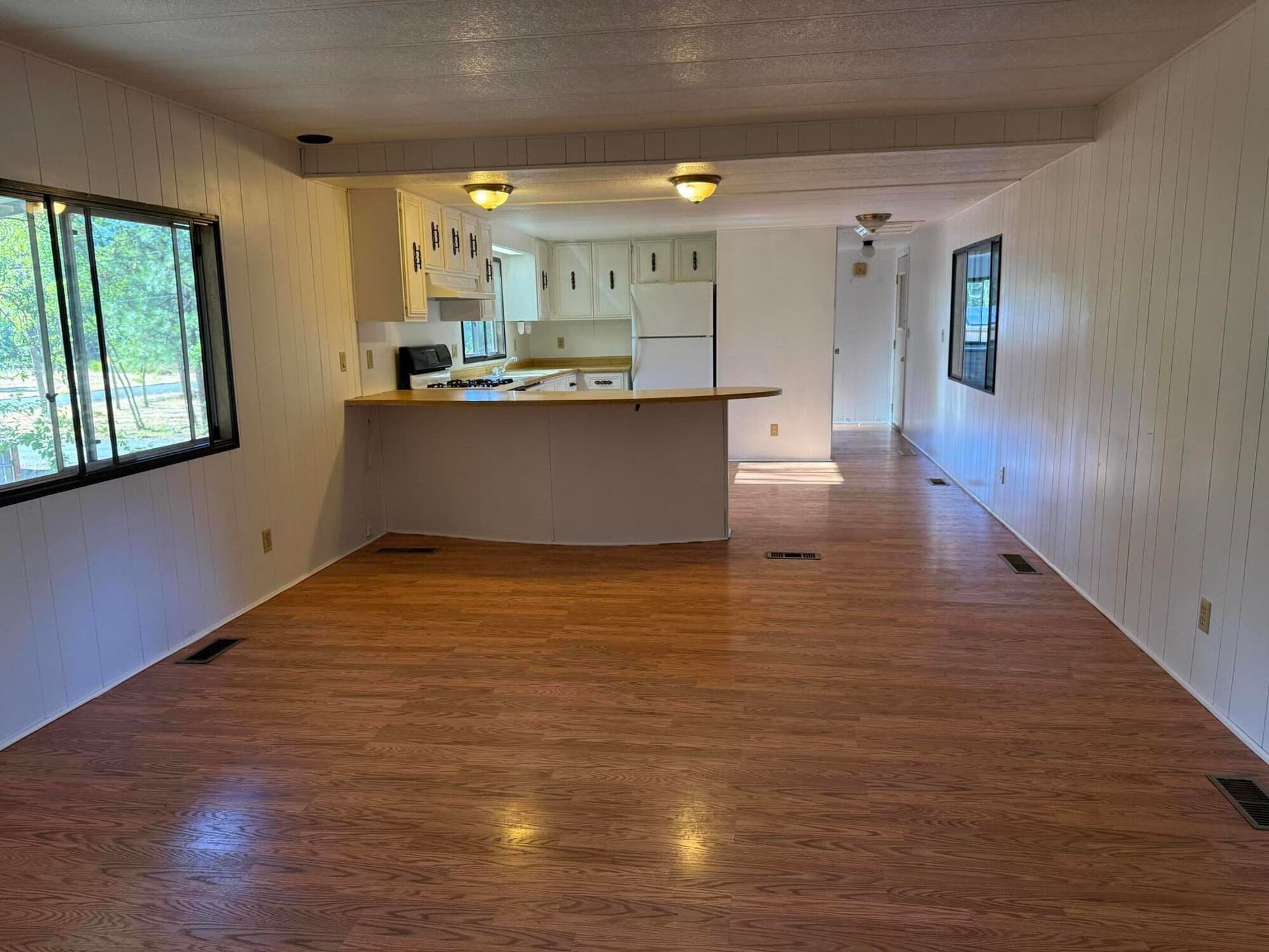 living room towards kitchen. Photo 5 of 23, 105 Raymond Street, Cave Junction, OR 97523