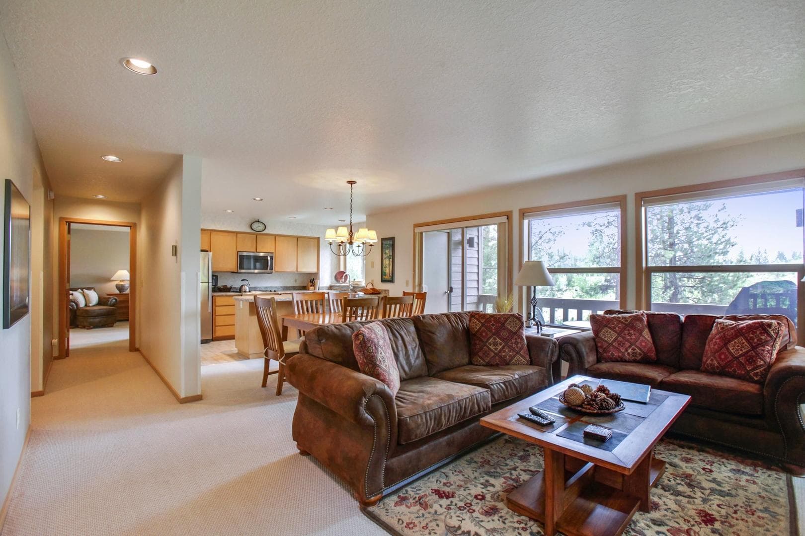 Living room view from entry down hall. Photo 2 of 28, 57321 Beaver Ridge Loop Unit 1, Sunriver, OR 97707