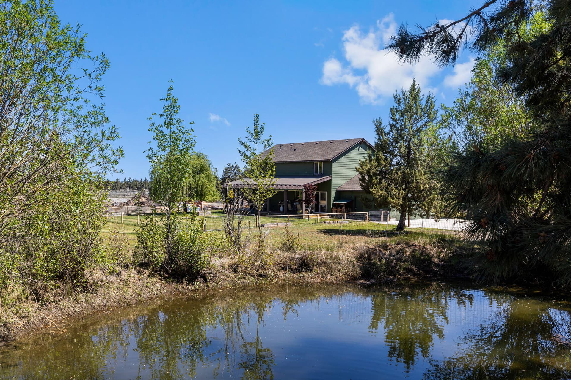 Gentry house from pond. Photo 2 of 48, 63639 Gentry Loop, Bend, OR 97701