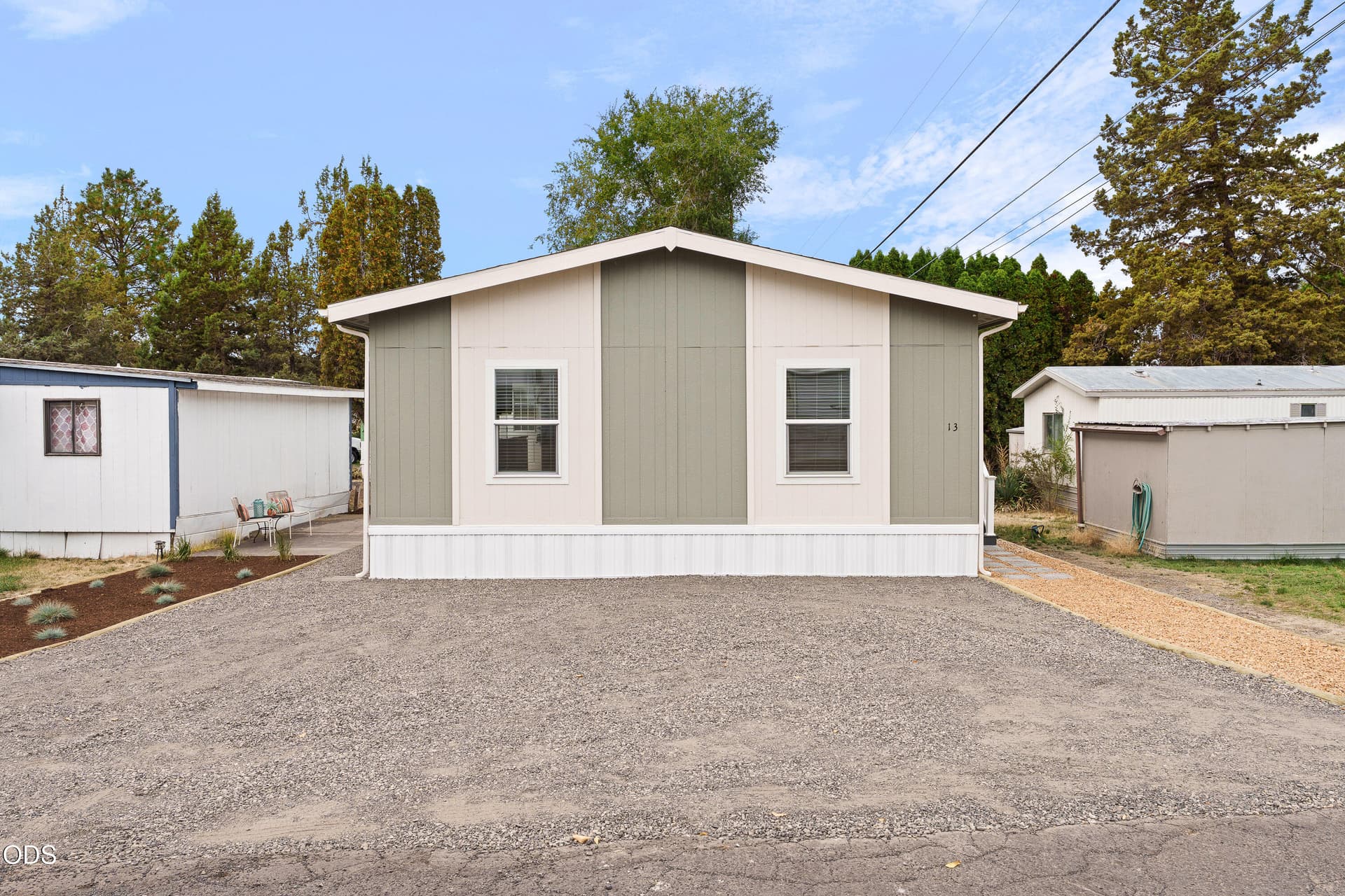 Front exterior with gravel parking. Photo 2 of 35, 5063 S Highway 97 Unit 13, Redmond, OR 97756